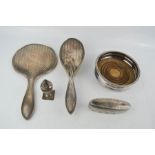 A silver hand brush and hand mirror, a silver salt shaker, and a silver lidded trinket box, together