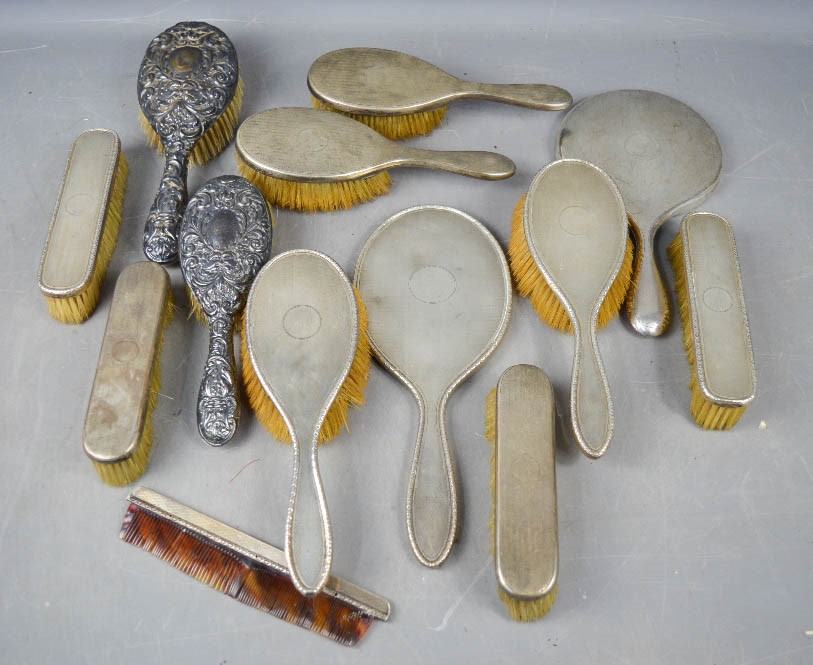 A group of silver dressing table sets, including mirror, hand brushes, clothes brushes etc.