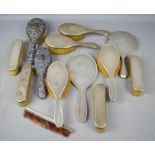 A group of silver dressing table sets, including mirror, hand brushes, clothes brushes etc.