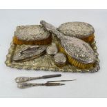 A silver plated tray, together with three silver dressing table brushes, a part silver dressing