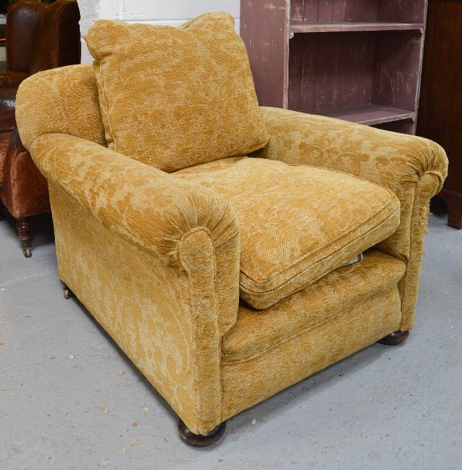 A late 19th/early 20th century upholstered armchair.