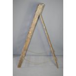 A set of antique wooden ladders.