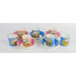 A group of German porcelain coffee cans and saucers, with pink and blue ground, each depicting