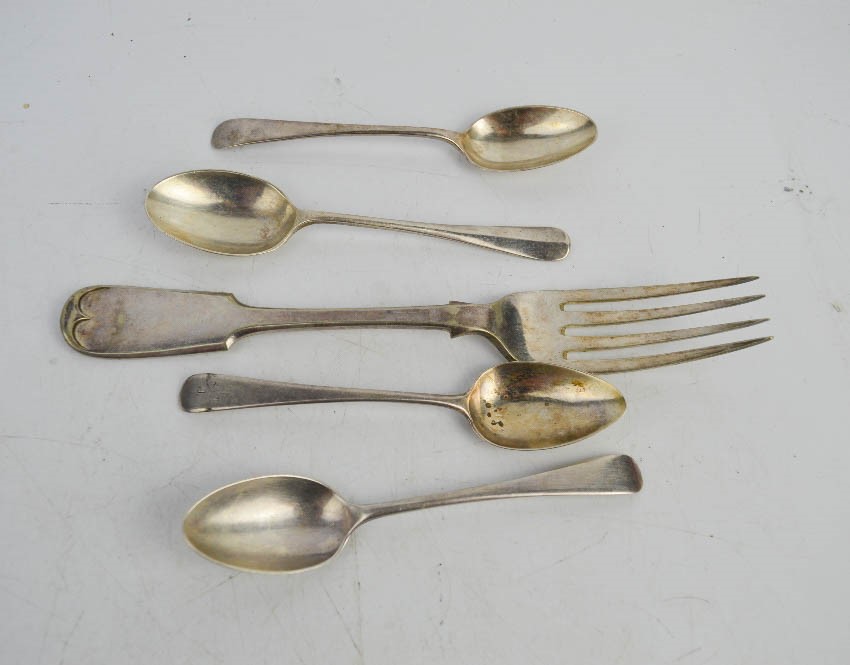 Four silver spoons and a silver fork.