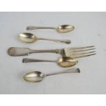 Four silver spoons and a silver fork.