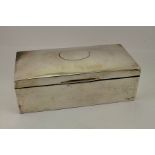 A silver cigarette box, cedar wood lining, worn Chester hallmarks, 15.81toz total.