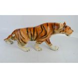 A Royal Dux porcelain tiger 20cm high.