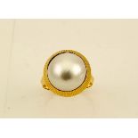 An 18ct gold (tested) pearl ring, size O, 5.4g.