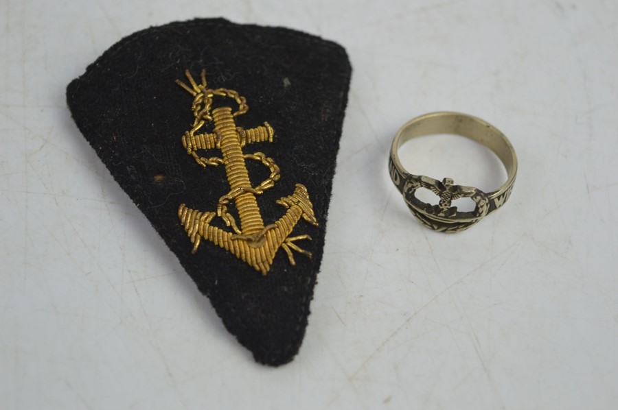 A German Kriegsmarine badge together with a Kriegsmarine ring
