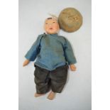 A rare Chinese doll, made in Hong Kong, the wooden face, hands and feet hand painted, with canvas