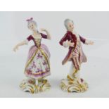 A pair of German porcelain Volkstedt 1762 figurines impressed V20655 and V20656 to the bases, 12