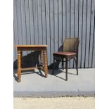 A oak table together with a rattan style chair