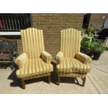 A pair of high back armchairs in a yellow stripe pattern