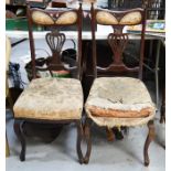 A pair of Edwardian mahogany chairs with shaped and pierced splats.