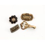 Three Victorian gold (unmarked) mourning brooches, one of flowerhead form, with woven hair set