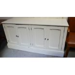 A modern cream painted sideboard, with panelled doors.