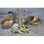 A group of silver plate ware to include pair of candlesticks, fruit basket. toast rack, flatware,
