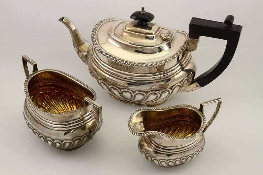 A silver three part tea set, comprising teapot, milk jug and sugar bowl, gilt interior, Birmingham