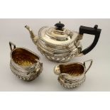 A silver three part tea set, comprising teapot, milk jug and sugar bowl, gilt interior, Birmingham