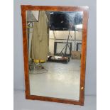 A 1940s burr walnut veneered wall mirror, 116 by 72cm.