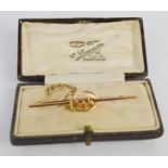 A 9ct gold sweetheart brooch, set with amber coloured stones, with safety chain, with box. [All