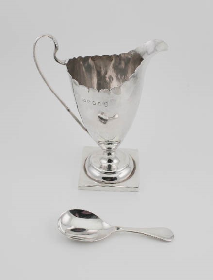 A silver jug and a silver christening spoon, 3.68toz.