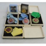 A group of teaching medals, some boxed, mostly from the teaching society.