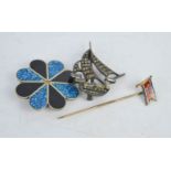 Two brooches; one in the form of a ship, and another set with marcasite, together with a hat pin. [