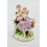 A German porcelain figure group, DR 1885, young girl and boy with lamb at the foot, 17cm high.