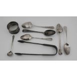 A group of silver to include a pair of silver sugar tongs, napkin ring and spoons. 4.94toz.