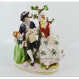 A German Democratic Republic porcelain figure group, lady and gent with young girl, 20cm high.
