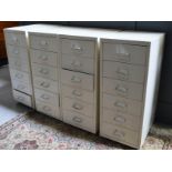 Four metal filing cabinets each with six drawers.