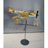 A model spitfire raised on a weathervane, of wooden inner construction, with the outer