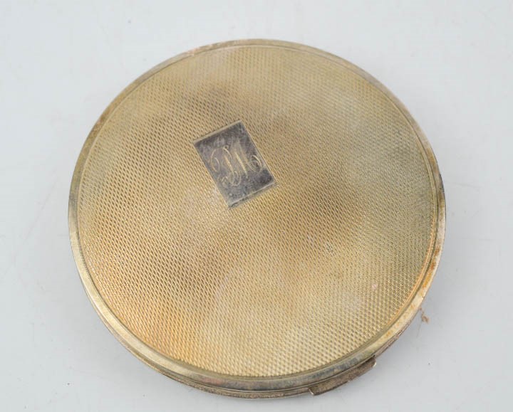 A silver compact, with machine engraved decoration and initials P.M., Birmingham 1920.