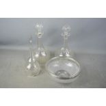 A pair of cut glass decanters, and a siver rimmed cut glass bowl.