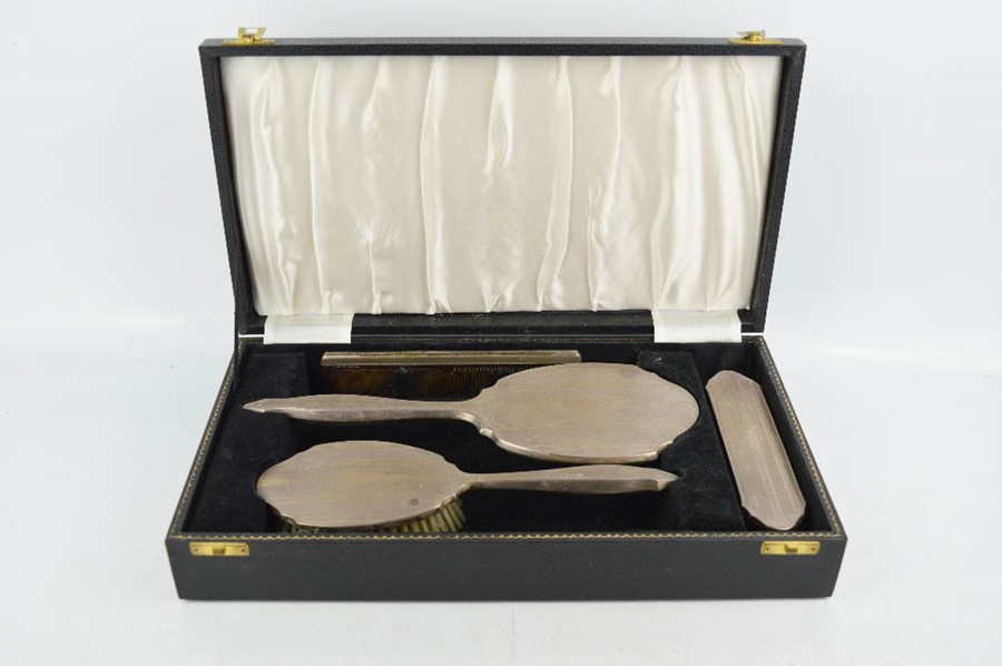 A silver dressing table set, comprising hair brush, hand mirror, clothes brush and comb, in