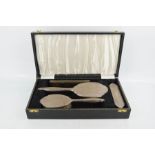 A silver dressing table set, comprising hair brush, hand mirror, clothes brush and comb, in