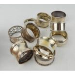 A group of six silver napkin rings of various form, 2.47toz, and four silver plated examples.