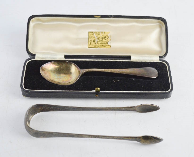 A silver christening spoon (boxed) and pair of silver sugar nips.