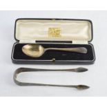 A silver christening spoon (boxed) and pair of silver sugar nips.