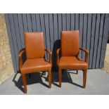 A pair of leather look high back chairs