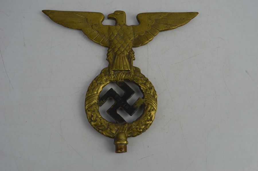 A German Nazi brass emblem possibly a flag pole top marked Erwin 1928