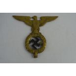 A German Nazi brass emblem possibly a flag pole top marked Erwin 1928