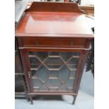 An Edwardian mahogany cabinet with single drawer and glazed door enclosing shelves, 87 by 50 by