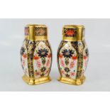 A pair of Royal Crown Derby bone china Imari pattern salt and pepper, XLVI, 9½cm high.
