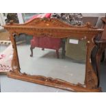 A gilt over mantle mirror