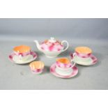 A tea for two lustre set in pink and orange.