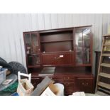 A mahogany style sideboard with lighting