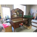 An Edwardian sideboard with carved decoration to the front.