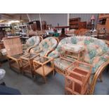 A wicker conservatory set, including settee and two armchairs, and a group of wicker tables and a